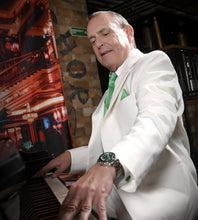 Load image into Gallery viewer, Man in an ivory tuxedo playing a piano in a bar setting