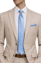 Load image into Gallery viewer, Man wearing a beige suit with a light blue tie and pocket square on a white background