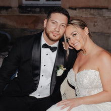 Load image into Gallery viewer, Man in tuxedo and woman in wedding dress posing together.